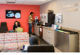 students hanging out in the Graduate College suite getting coffee, taking, studying