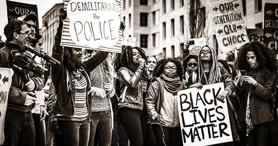 Protestors holding signs that say Black Lives Matter