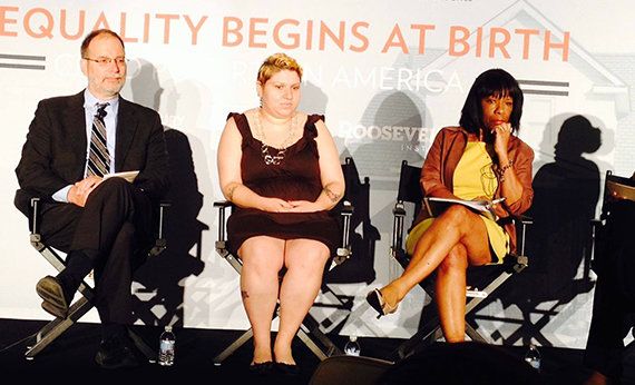 Witnesses member Joanna sitting on stage with two other presenters in front of Inequality Begins at Birth sign