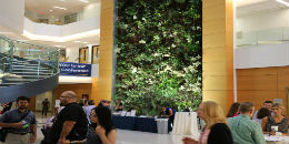 Conference attendees networking in front of reception area in Drexel Integrated Science Building