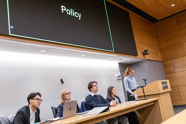 A clinic student gives a policy presentation to the startup community.