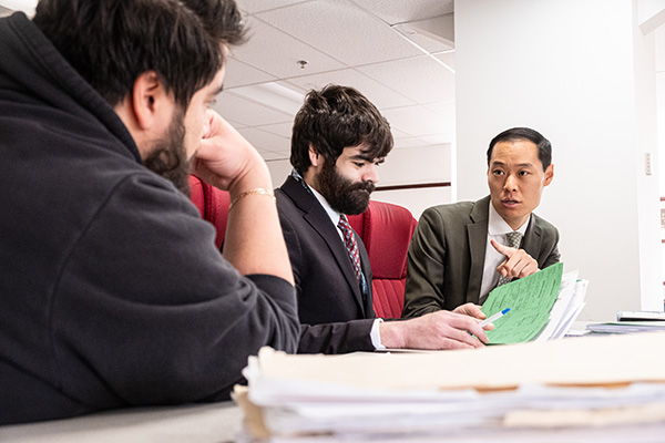 Director Dan Borgia speaks with students in the Defender Association practice courtroom.