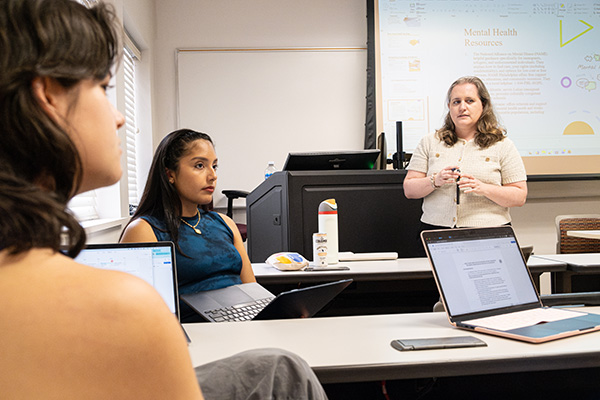 Director Tuohy speaks with students about their policy projects.