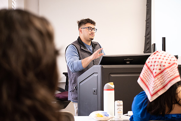 A student at a lectern gives a policy presentation.