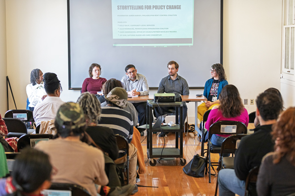 A room full of undergraduate students and community members listen to four panelists during an event about Storytelling for Policy Change.