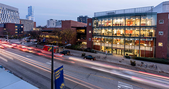 Drexel Kline School of Law exterior building at night with traffic on Market St.