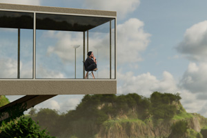 Man sits cross-legged in chair within an a modern-looking space with large glass windows looks out at mountainous, green landscape.