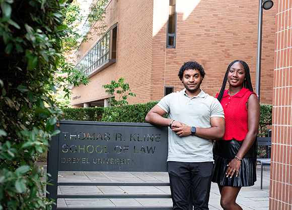 Josh Ventura and Deaven Ross pose for a photo next to the Drexel Kline Law courtyard gate.