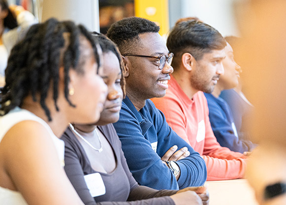 Close-up of four people at a table during a speed networking event.