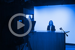 Professor Chapin Cimino prepares to talk on camera in studio