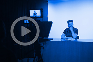 Professor Adam Benforado prepares to talk on camera in studio