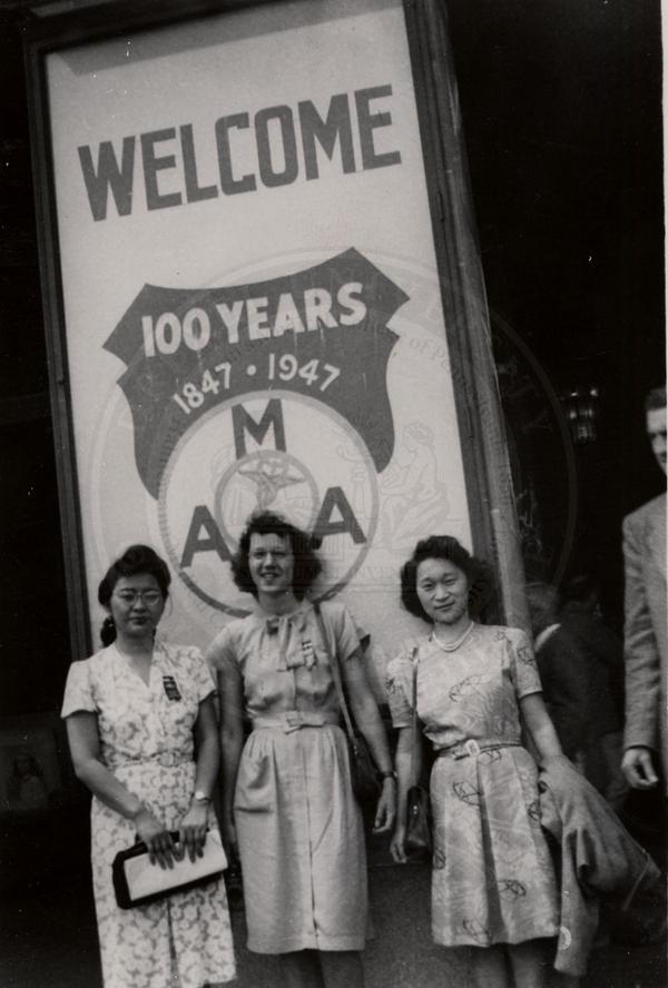 Kazuko Uno and Ruby Ayako Inouye with an unnamed student in front of American Medical Association welcome sign at the Convention Hall in Atlantic City, New Jersey. (The Legacy Center Archives and Special Collections)
