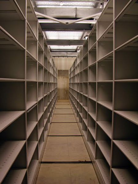 Empty stacks shelving aisles. (The Legacy Center Archives and Special Collections)
