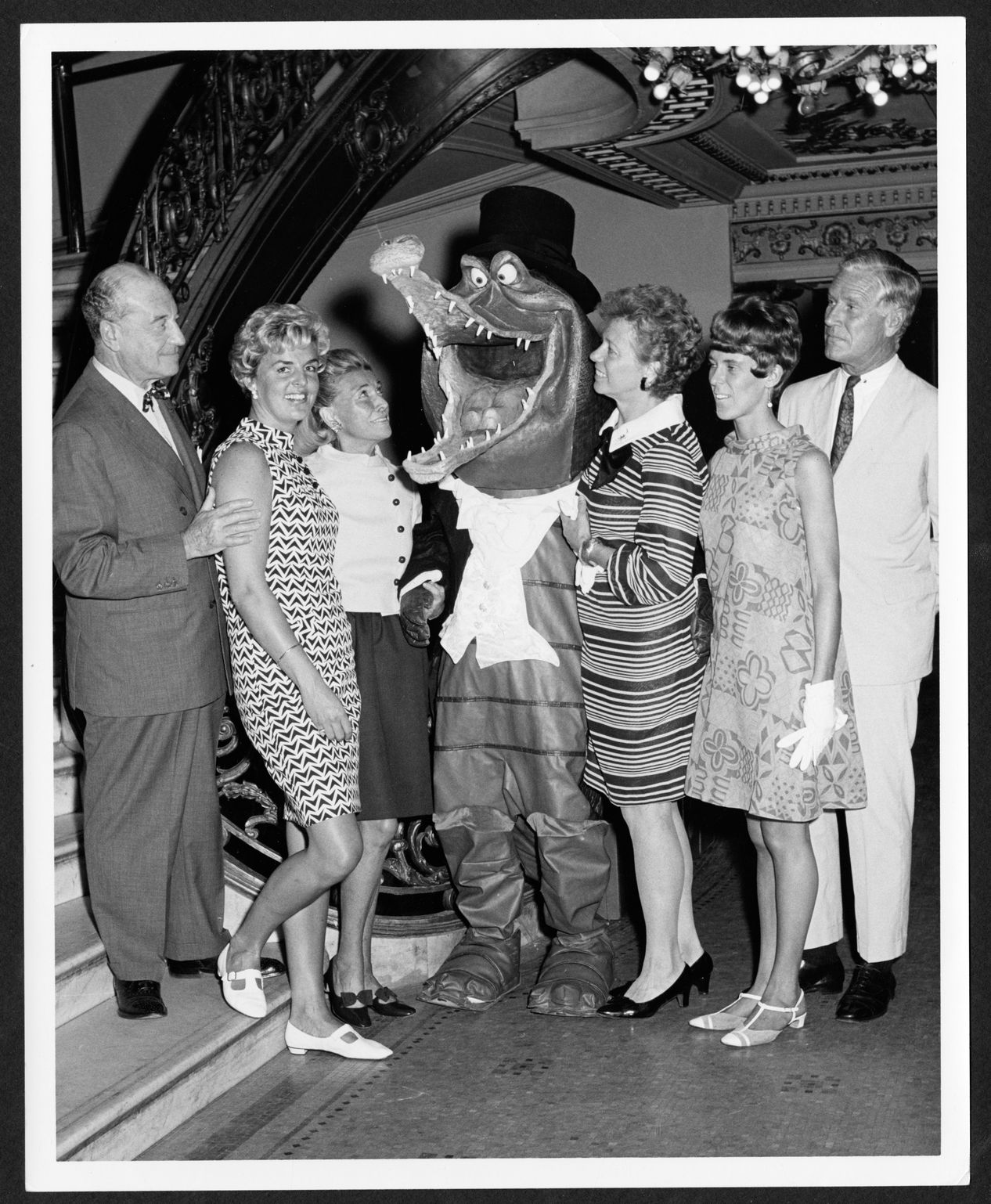 Black and white photograph of committee members and person dressed as an alligator or crocodile, for the Happiest Millionaire benefit, Philadelphia, 1967 (The Legacy Center Archives and Special Collections, p4744)