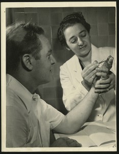 Dr. Alma Dea Morani repairs the damaged fingers of a patient in the Hand Clinic, undated (The Legacy Center Archives and Special Collections)