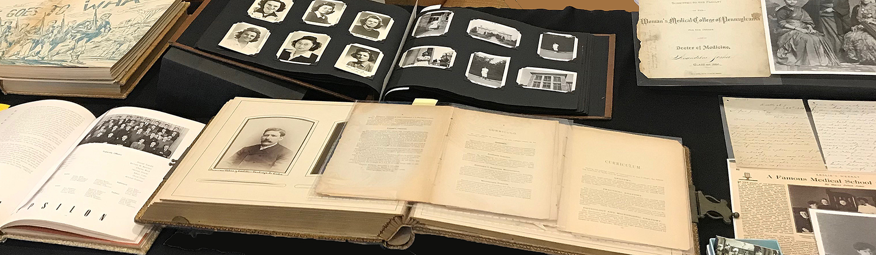 Exhibit of scrapbooks, photo album, yearbooks and other materials (The Legacy Center, Archives and Special Collections).