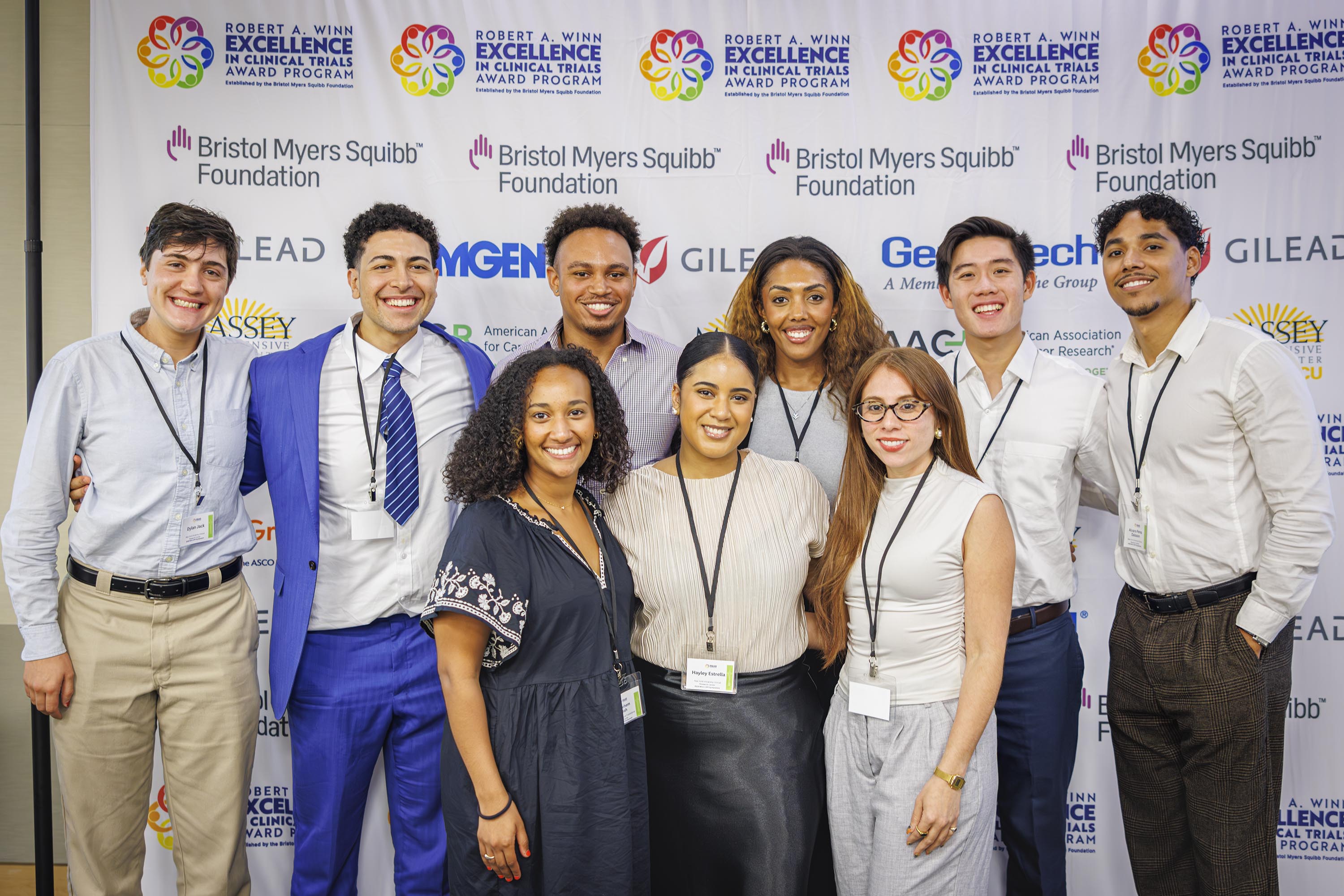 9 people stand in group photo