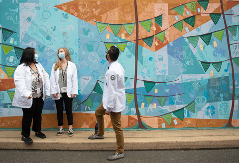 Students from the inaugural class of the new College of Medicine at Tower Health campus painting a community mural sponsored by ruOK Berks?