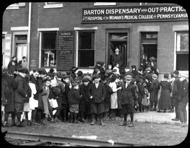 Large crowd outside of the Amy S. Barton Dispensary (The Legacy Center Archives and Special Collections)