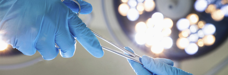 Close-up of gloved hands passing the surgical scissors.
