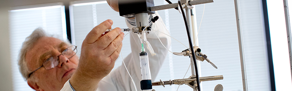 Biomedicine graduate research program faculty working in lab.