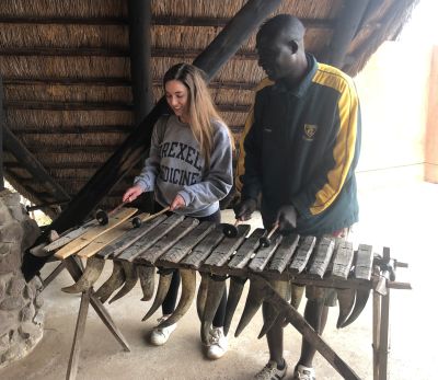 Global health scholar Debi Smith playing music in Zambia