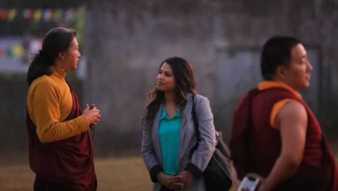Debika Biswal Shinohara speaking to a man during their global health experience in Bhubaneswar, India