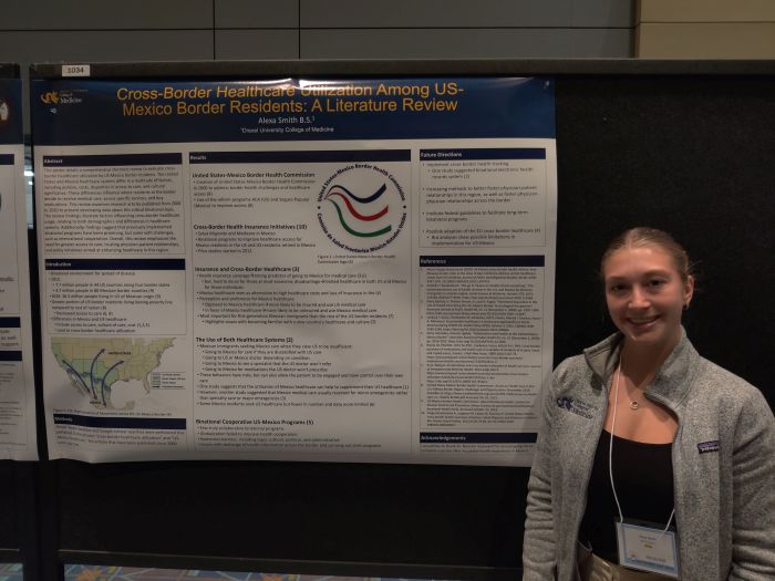 MD student Alexa Smith next to her global health poster at Drexel's Discovery Day