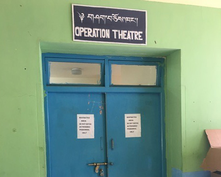 Drexel medical student Matthew Recker in Paro, Bhutan with Surgicorps - Operation Theatre Door.