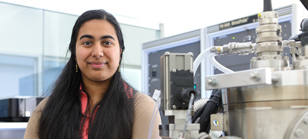 Drexel graduate student working in a biomedical research lab, standing next to laboratory equipment.