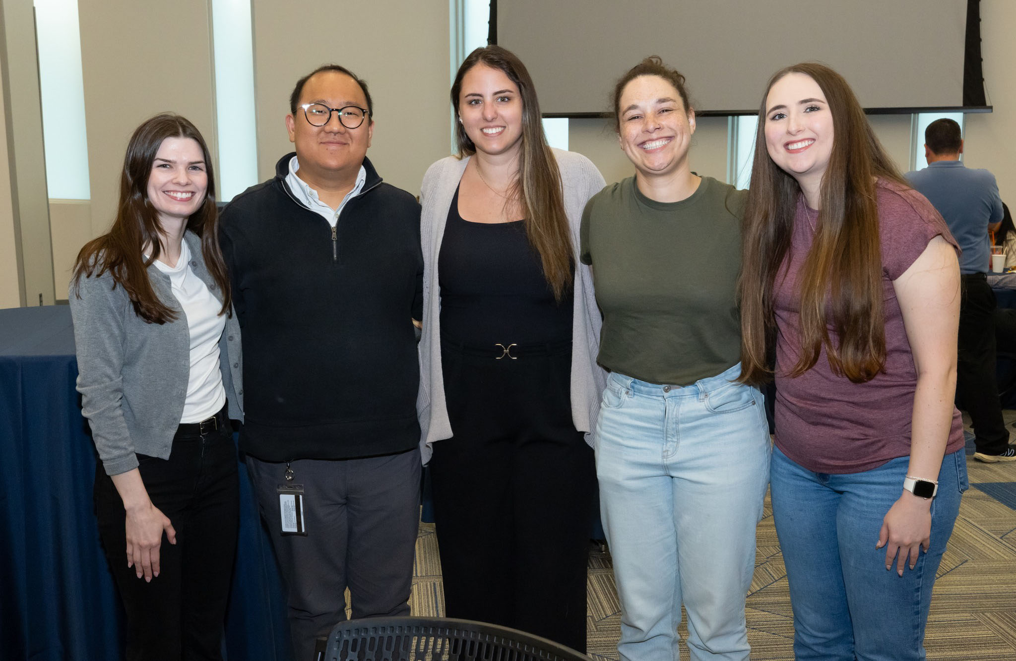 five people smiling