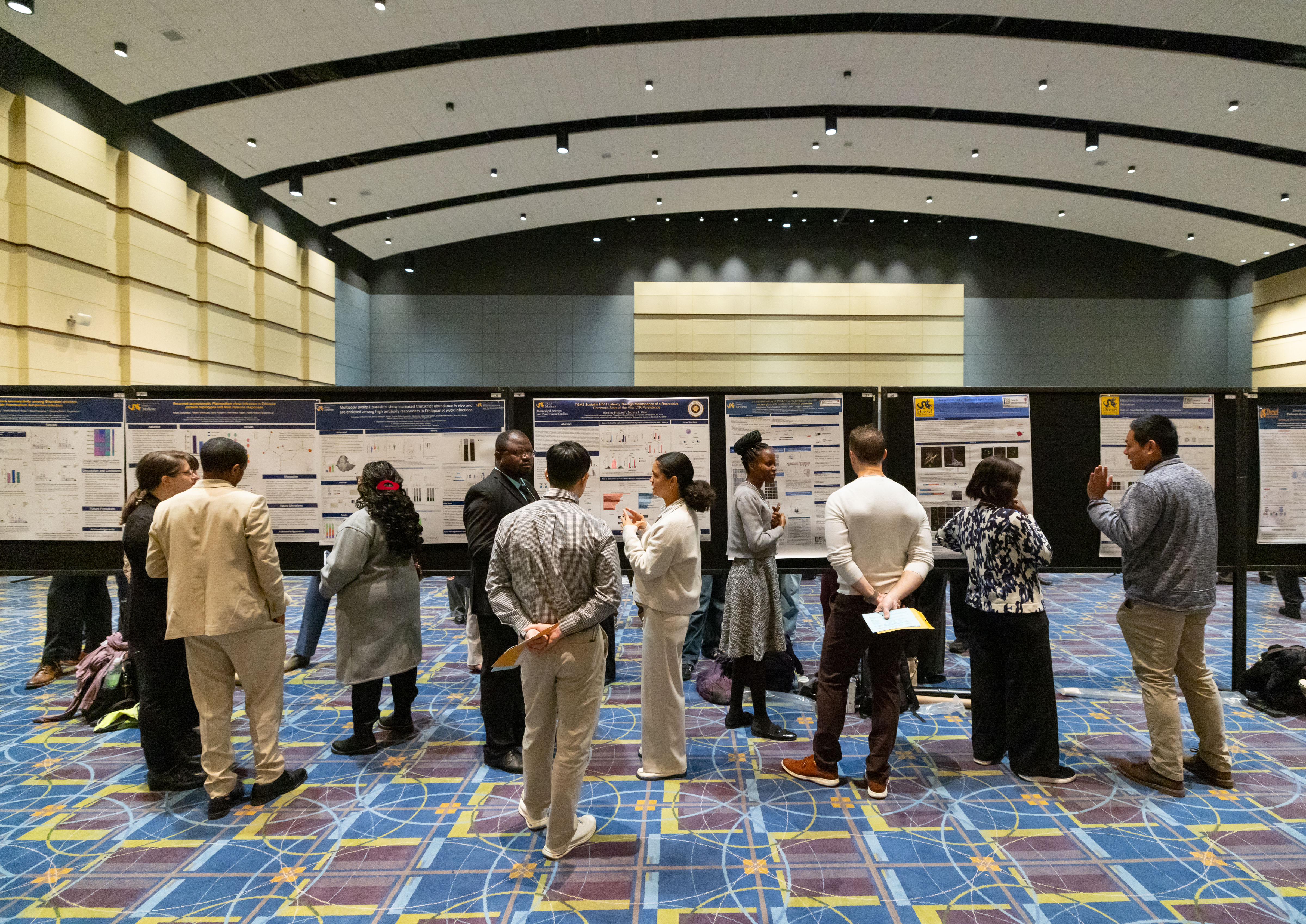 a photo of posters on display as people read them