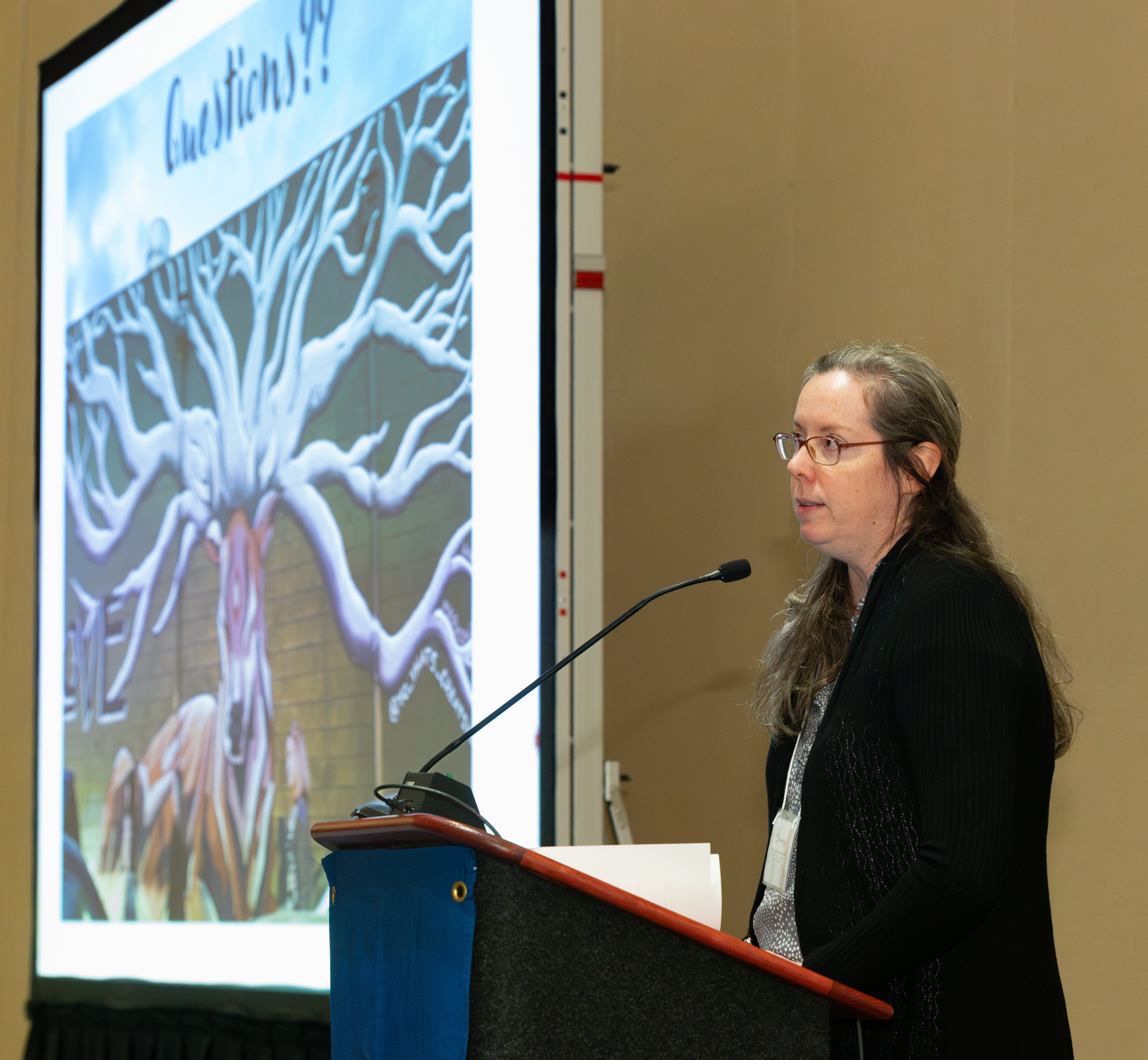 woman speaks at podium