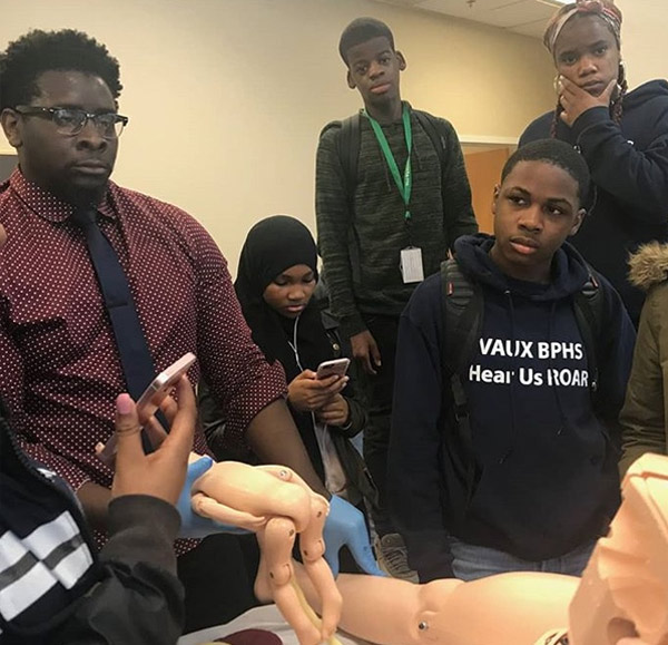 Students from Vaux BPHS watch a simulated labor and delivery during their visit to the Queen Lane Campus