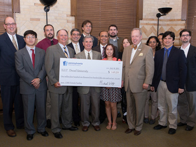 Drexel researchers join Dean Schidlow and Vice Dean Simansky in celebrating an award of $1.4 million in grant money from the Commonwealth of Pennsylvania. Also pictured are PA Secretary of Health Michael Wolf (back row, 1st from left), and PA State Rep. William Adolph, chairman of the House Appropriations Committee (front row, 2nd from left).
