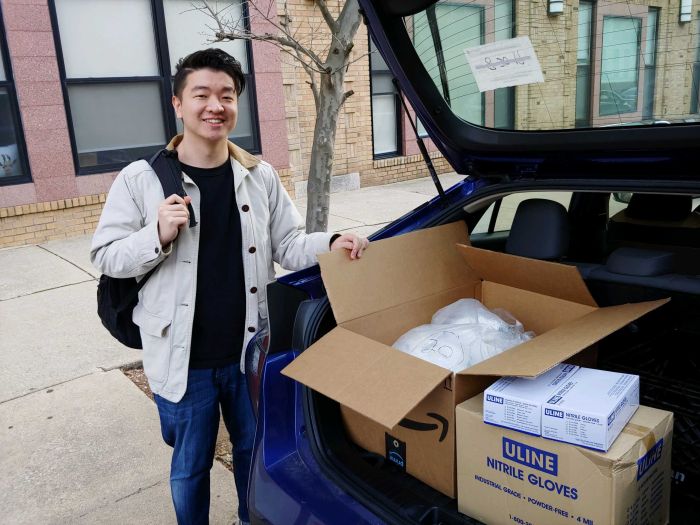 MD student Edward Guo with a trunk full of PPE