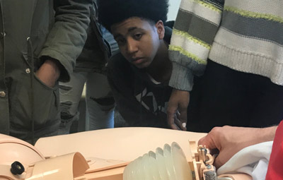 Student at Vaux BPHS watching a labor and delivery simulation