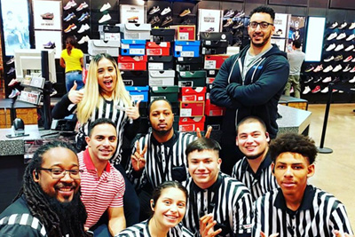 Master of Science in Interdisciplinary Health Sciences (IHS) program graduate student Sam Sayed with staff at Foot Locker in Arlington, Texas.