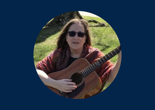 Woman playing guitar outside