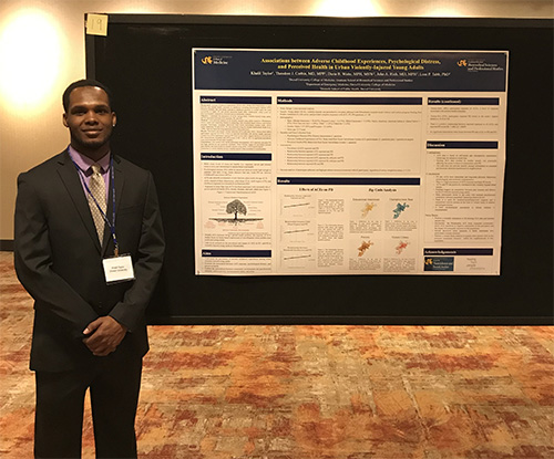 Master of Science in Interdisciplinary Health Sciences (IHS) program graduate student Khalil Taylor with his poster, 'Association Between Adverse Childhood Experiences, Psychological Distress, and Perceived Health in Urban Violently-Injured Young Adults'