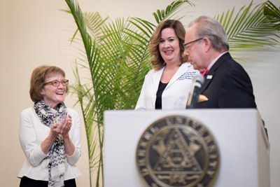 Deborah Tuttle receives a crystal apple from Dean Schidlow to honor her commitment to excellence in medical education, after the installation of Valerie Weber (center) as the inaugural Tuttle-Piper Vice Dean for Educational Affairs.