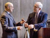 Dr. Codella receives the gavel from outgoing president Timothy Manzone, MD, MCP '89