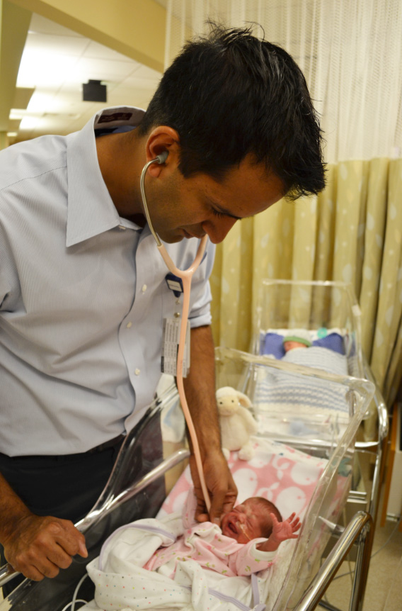 Anup Katheria, MD, examining a newborn.
