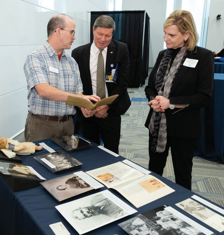 At a September welcome event, Legacy Center archivist Matt Herbison shared archival materials with attendees, including Dean Charles B. Cairns, MD, and Senior Vice Dean for Faculty Nancy Spector, MD.