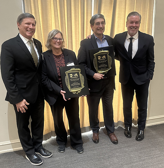 Dean Charles B. Cairns, MD, (left) and President John Fry (right) were present to honor Noreen Robertson, DMD, and Kenny Simansky, PhD, with Lifetime Achievement Awards at the SKCC Research Consortium retreat in February.