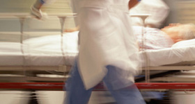 Blurred emergency patient being moved in a hospital.