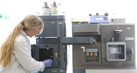 Female graduate student demonstrating lab equipment at Drexel University College of Medicine.