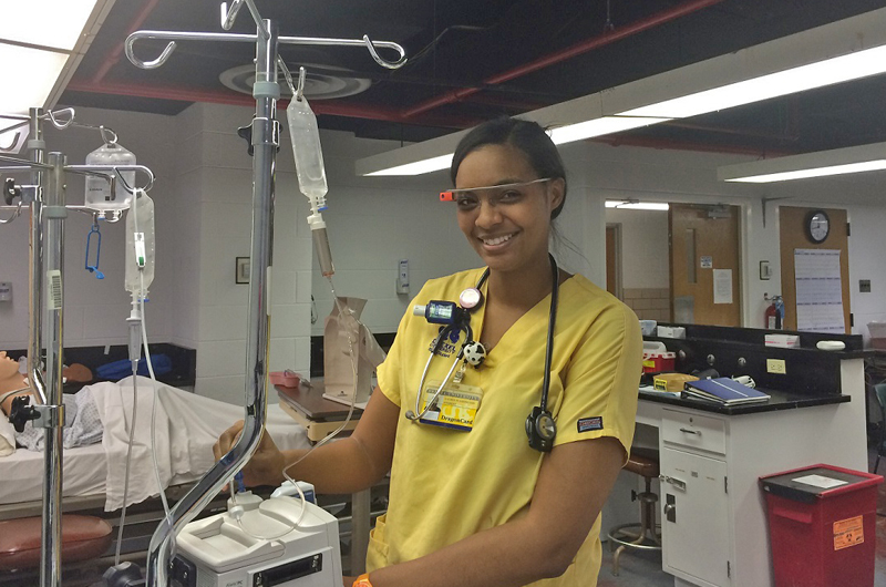Lauren Boehm, co-op nursing student, displaying the Google Glass nursing students at Drexel can use to train.