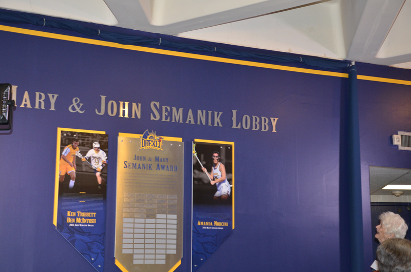 Semanik admiring the newly adorned wall in the Daskalakis Athletic Center named after her and her late husband, John.