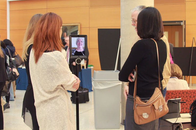 Attendees at the third Collaboratory event chat with Karyn Holt via a robot.